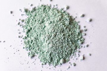 Natural colored pigment powder close up, matt pastel green eyeshadow or powder mica pigment on a...