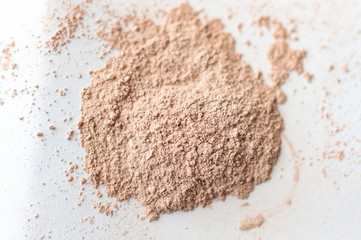 Natural colored pigment powder close up, matt eyeshadow or powder pigment on a white background