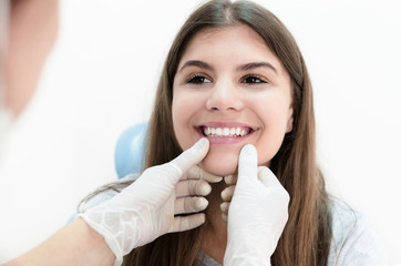 Young patient smile while dentist is cheking up her teeth