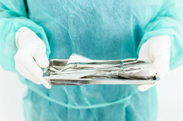 Dentist holding pot with dental tools