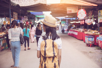 Fototapeta premium Teenagers backpacking along the market with many tourists - concept lifestyle