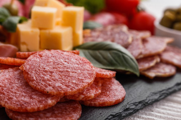 Cold smoked meat plate on a rustic wooden background