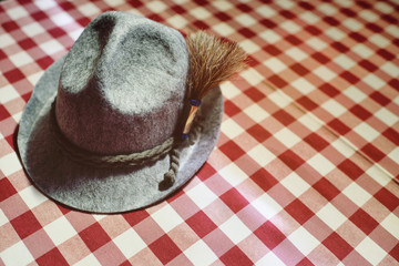 traditional Bavarian hat close-up on a red and white checkered background. Oktoberfest. Copy space, your text
