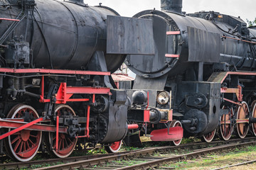 Fototapeta na wymiar Old disused retro steam black train locomotives