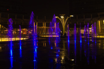 Milan, Italy, Financial district night view. Illuminated water fountains