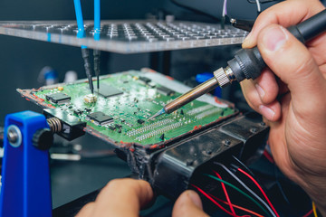 Repair of electronic devices, soldering and circuit board - obrazy, fototapety, plakaty