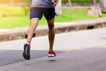 Athlete running at park outdoor in the morning.