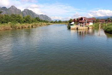 Fototapeta na wymiar Vang Vieng, Laos - January 1, 2016 : Song River, Popular with tourists who come to Vang Vieng
