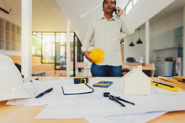 Engineer man working in the office, Drawing the construction project.