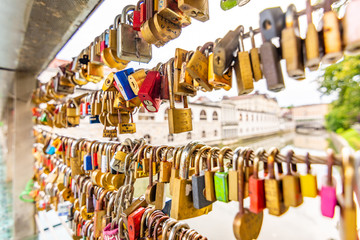Bridge in Ljubljana city, with locks as symbol of love. Romantic tradition in Slovenia capital.