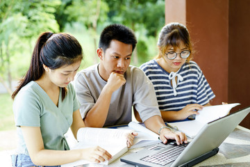 High school students; Group of happy teen Asian high school students outdoors; Group of cheerful the homework at school.