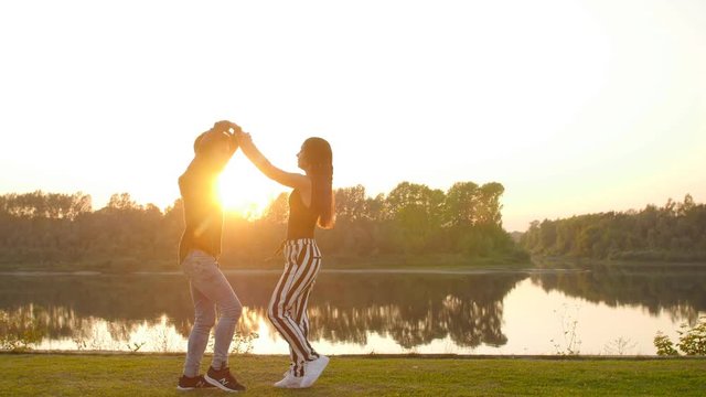 Concept of love and relationships Couple dancing bachata at sunset