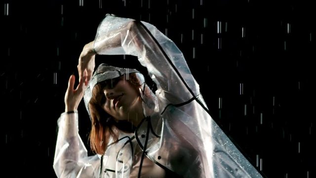 Beautiful woman dancing in the rain. Slow Motion.