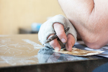 A man will engrave on a granite