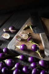 Eggplant violet preparation for cooking with old kitchen style wooden background materiel.