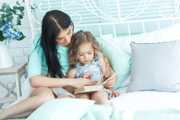 Loving mother reading a goodnight story to her child