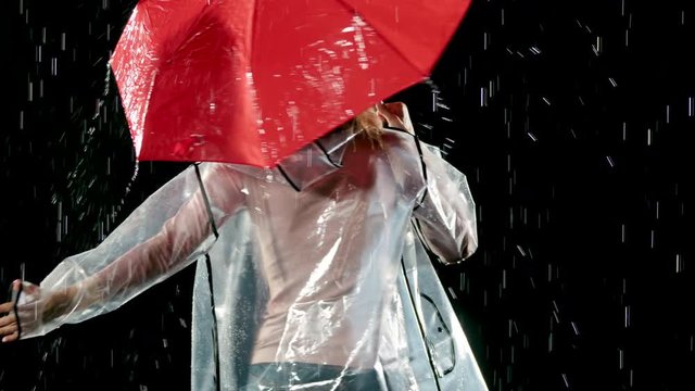 Beautiful woman dancing in the rain. Slow Motion.