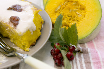 Pumpkin homemade cheesecake with white cream. Autumn still life. Thanksgiving day food.