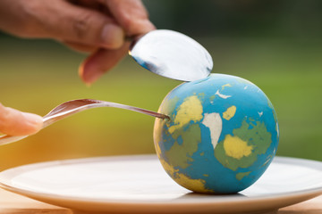 Globe model placed on plate with fork spoon for serve menu in famous hotels. International cuisine is practiced around the world often associated with specific region country. World food inter concept