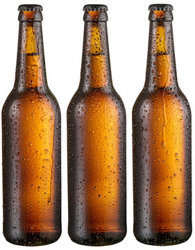 Three bottles of cold beer with big condensate drops.