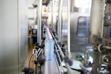 Bottling plant - Water bottling line for processing and bottling carbonated water into bottles. Selective focus.