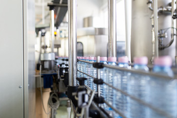 Bottling plant - Water bottling line for processing and bottling carbonated water into bottles. Selective focus.