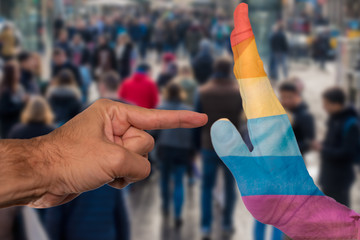 Finger pointing to a peaceful hand with pride flag