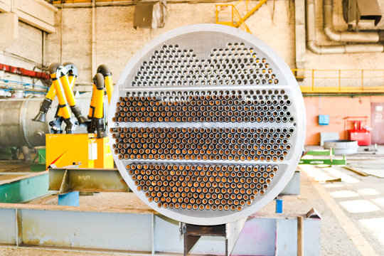 Production of a large tube bundle for a shell-and-tube heat exchanger in an industrial production room of a shop with equipment at an oil refinery, petrochemical, chemical plant, enterprise