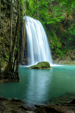 Beautiful waterfall in green forest in jungle, Thailand. © yotrakbutda