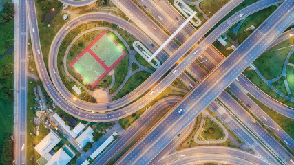 Aerial view highway road circle or intersection at dusk for transportation, distribution or traffic background.