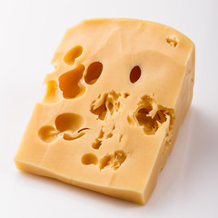 Piece and slices of cheese on a white background