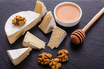 delicious creamy camembert cheese on a wooden rustic background