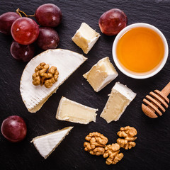 delicious creamy camembert cheese on a wooden rustic background