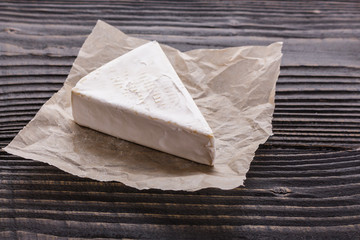 delicious creamy camembert cheese on a wooden rustic background