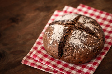 Fresh bread on wooden table.  Rye Bread on cutting board close up.
