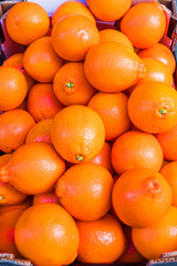 Fresh Mandarines or citrus oranges in a box on a farm organc market. Harvest concept. Top view