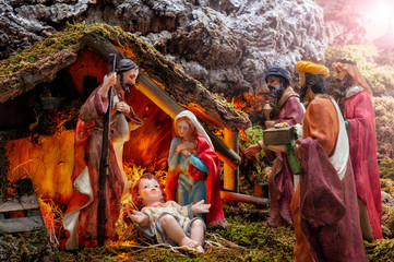 Christmas nativity scene with Holy Family in the hut and the three wise men.