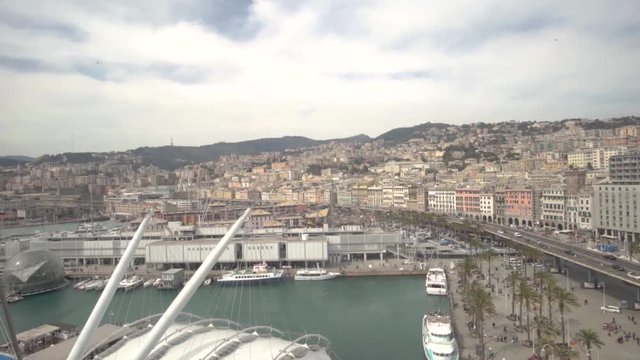 Aerial view of Geona (Genova) from bigo, the rotating panoramic tower over the celebrated acquarium. You can see cars traveling, the harbourd and the city.
