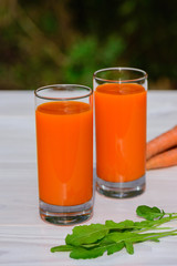 Carrot juice on a wooden table