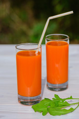 Carrot juice on a wooden table