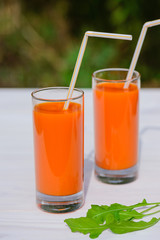 Carrot juice on a wooden table