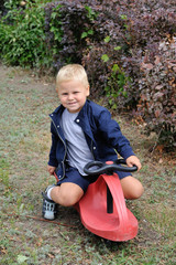 A boy is riding a car
