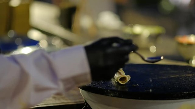Waiter roasts a burrito and adds oil on a hot plate.Burrito roast on a hot plate.4K video.