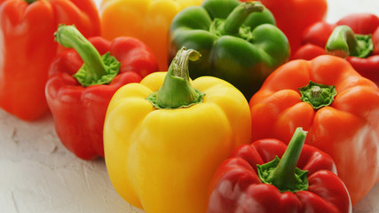 Bunch of bright multicolored bell peppers composed in bunch on wooden table