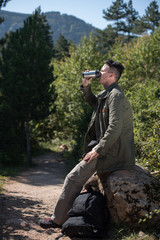 hiker drinking water from bottle on rest 