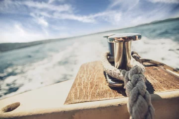 Gordijnen Close up of mooring rope on the boat that is sailing on the see © Daniel Krasoń