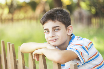 Young boy relaxing outdoors. Childhood concept