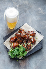 Asian chicken wings bbq with beer and coriander, copy space