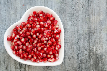 Pomegranate seeds  in white plate.