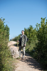Obraz premium portrait of hiker holding stick and in full gear 